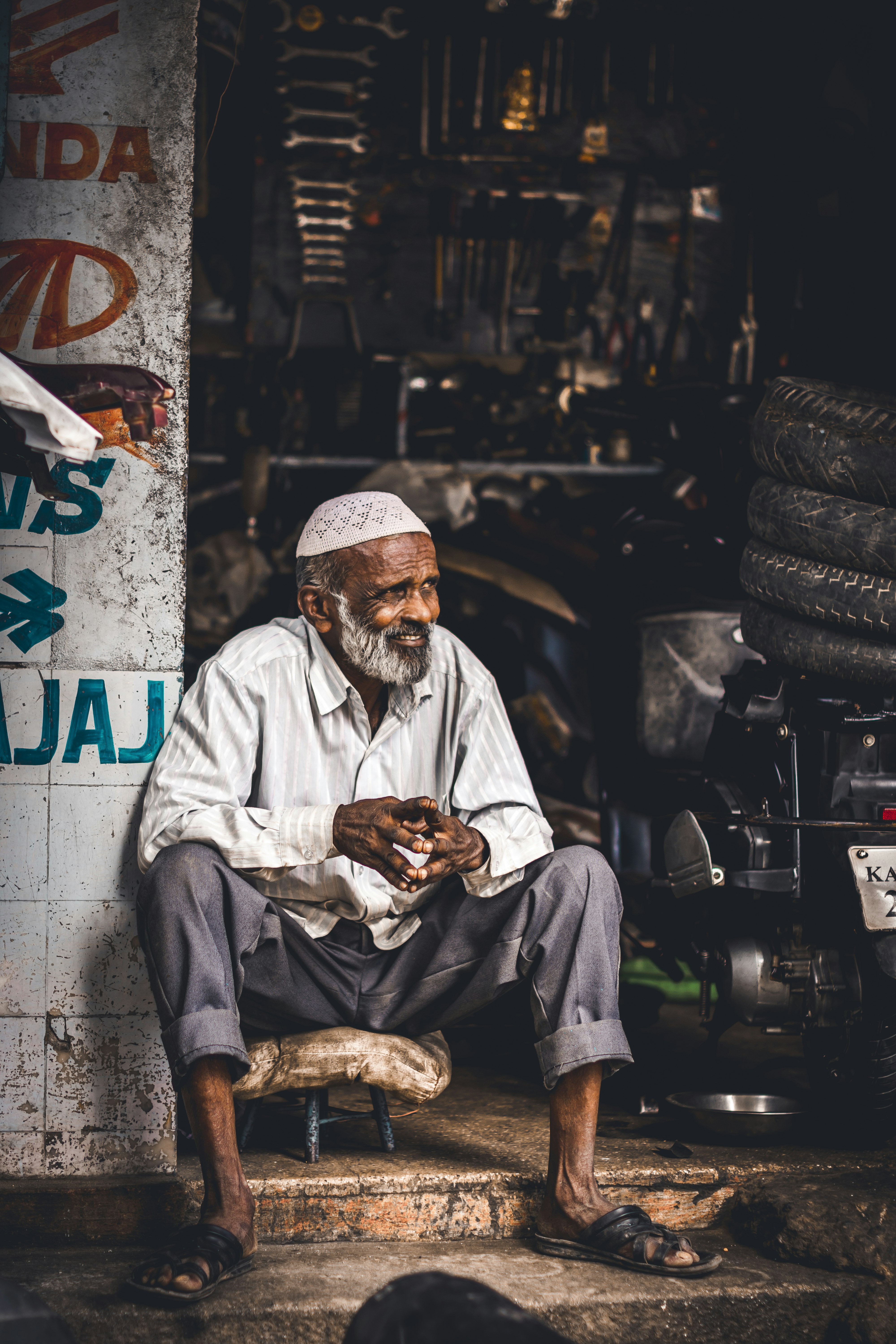 man in white thobe sitting on floor